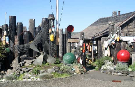 Fishing Floats, Nets and a Large Propeller beside Old Dock Piers