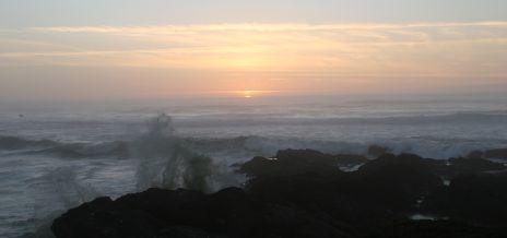 Waves Crashing Against Rocks at Sunset